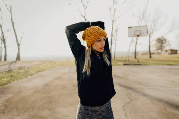 Photo of a sporty young woman exercising on a sports field
