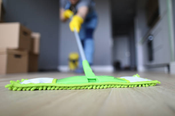 istock Male hand with yellow protective gloves hold green plastic mop 1220152456