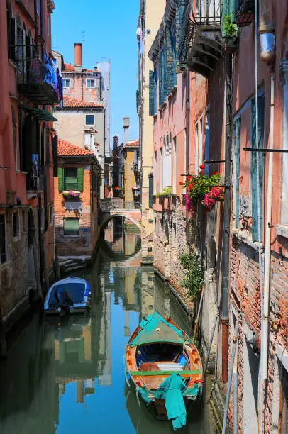 Photo of Scenic view of venetian canal with boat, Venice, Italy