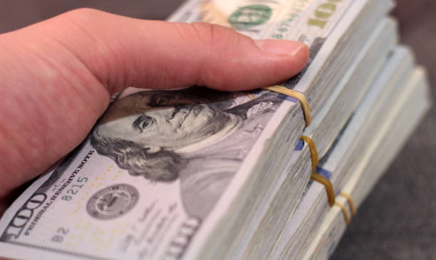 istock Stack of one hundred dollar bills close-up. 1220154394