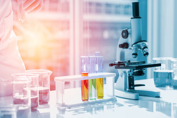istock Scientists put liquid in beakers and chemical test tubes in a science lab laboratory. About doing research for science concept 1220154400