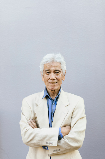 Portrait of smiling Asian businessman looking at camera.