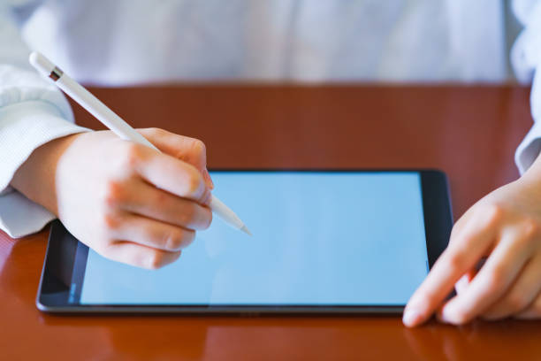 istock Studying girl by using pen tablet at living room 1220154955