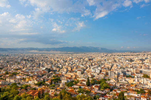 istock Blue Sky With Clouds Over the Roofs of Athens 1220155914