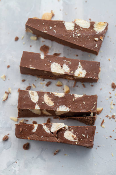 chocolate turron on ceramic background - torrone fotografías e imágenes de stock