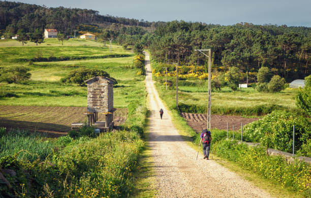 Pilgrims walking along on the Way of St. James, Galicia, Spain stock photo