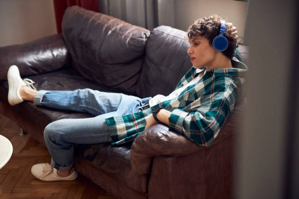 istock Attractive guy listening to music at home 1220161449