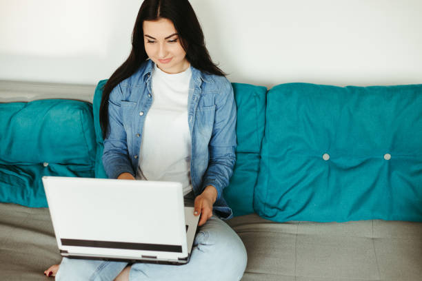 istock Young woman staying at home using laptop 1220161869