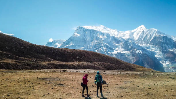 istock Ice Lake - A couple walking along a pathway with the view on Annapurna Chain 1220163464