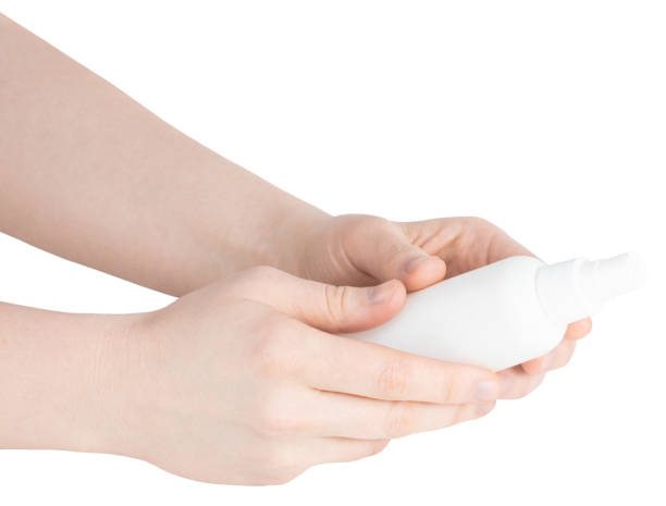 istock bottle with antibacterial antiseptic spray in hand isolated on white background 1220163899
