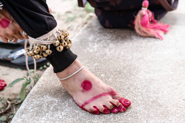 istock dance form indian classical feet with ghungru. Kathak Girl tying ghungaroo. close up, copy space. classical Indian culture and traditions 1220165280