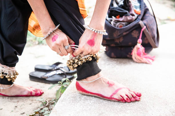 dance form indian classical feet with ghungru. Kathak Girl tying ghungaroo. close up, copy space. classical Indian culture and traditions. Odissi dancer