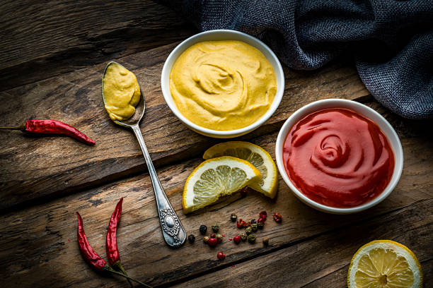 istock Ketchup, mustard and mayonnaise on rustic wooden table 1220165407