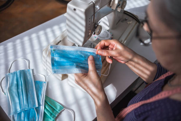 istock Woman working at the sewing machine at home 1220165520