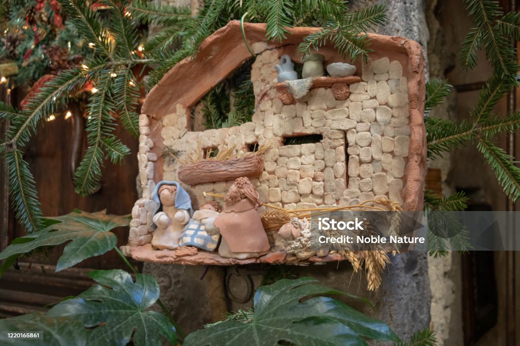 Homemade diy Christmas creche made of wooden pearl Santon de provence traditional Christmas crib decoration in the south of France - Lucéram Christmas Crib Festival Nativity Scene Stock Photo