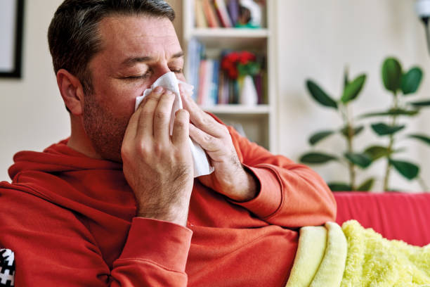 istock 30-39 years old man feels sick and bad. He lying down on sofa with blanket. 1220165930