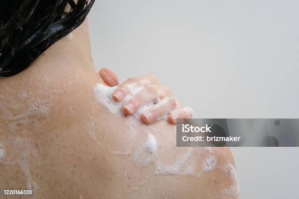 Young Adult Girl Taking Shower Standing In Bathroom Stock Photo - Download Image Now