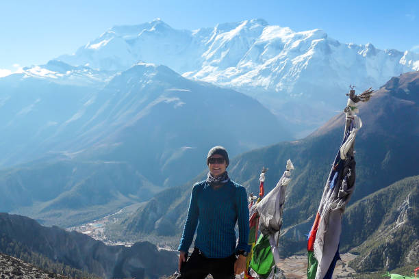 istock Ice Lake - A man standing next to a row of prayer flags 1220167205
