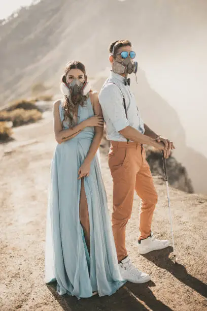 Photo of Man and woman standing in front of a mountain