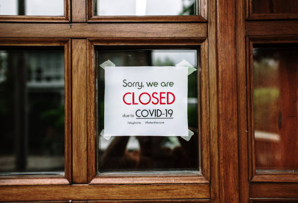 istock Closed due to COVID-19 sign on a window 1220167813