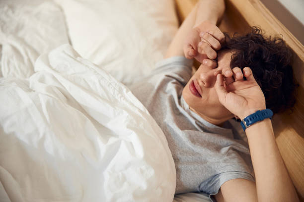 istock Handsome young man waking up early in the morning 1220168867