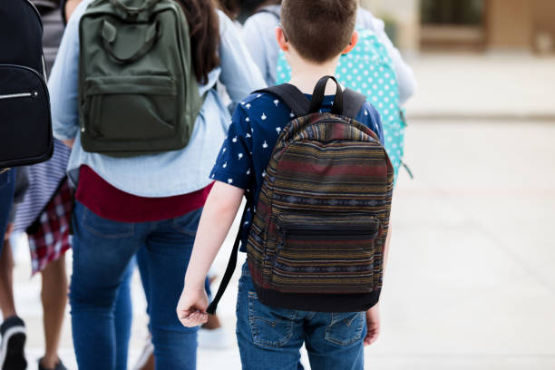 istock Rear view of student on crosswalk 1220169290