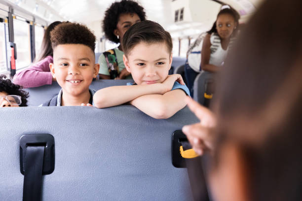 istock Unrecognizable girl directs game on school bus 1220169373