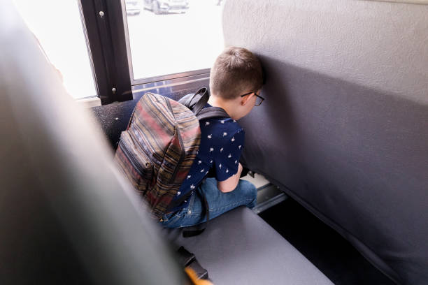 istock After hard day, young boy leans head on bus seat 1220169375