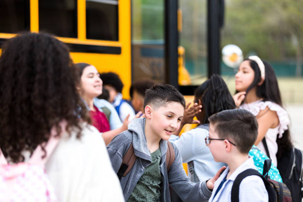 istock Brothers prepare to board school bus 1220169559