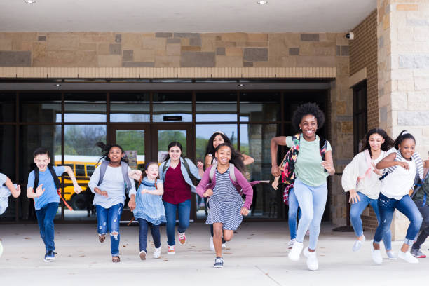 istock Excited schoolchildren leaving school 1220169565
