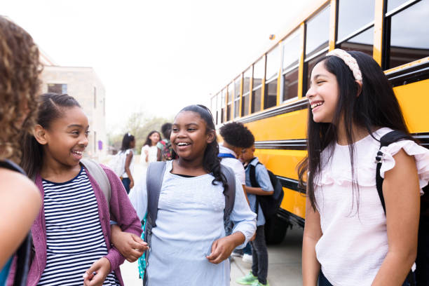 istock Happy girls talking after school 1220169580