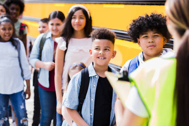 istock School children line up before boarding school bus 1220169586