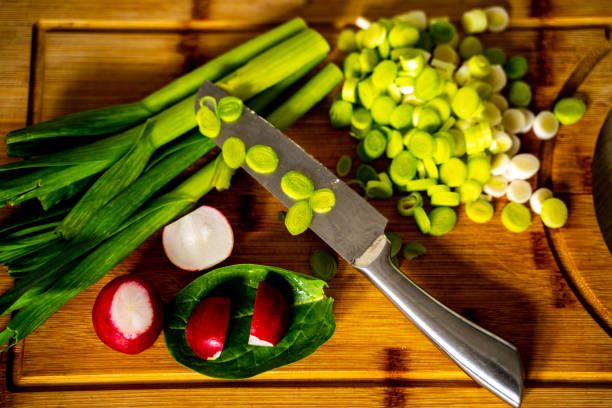 istock Chopped green garlic sprouts on cutting board and knife 1220170723
