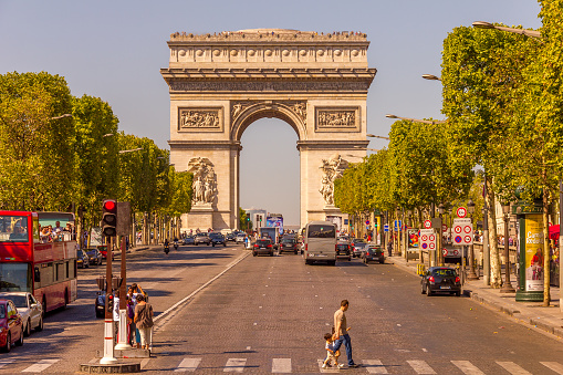 Paris, France - 9 September, 2012:  The Champs-Élysées and the Arc de Triomphe. The most famous avenue of Paris has 1910m and is full of stores, cafés and restaurants.