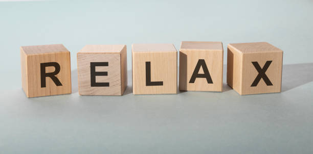 istock RELAX word written on wooden blocks. RELAX text on table, concept. 1220171834