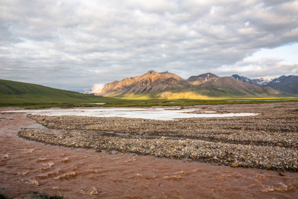 A storm swollen river flows towards Galbraith Lake along the Dalton Highway in Alaska.