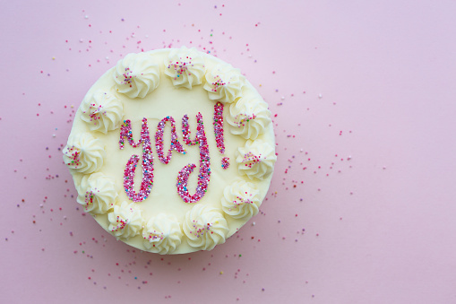 Birthday cake with yay written in colorful sprinkles