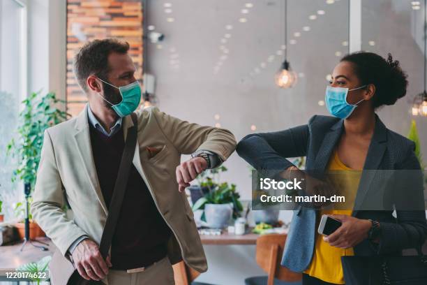 Business People Greeting During Covid19 Pandemic Elbow Bump Stock Photo - Download Image Now