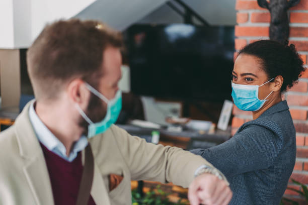 istock Business people bump elbows as greeting during COVID-19 pandemic 1220175105