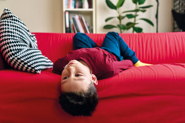 istock Bored child on living room. 1220176302
