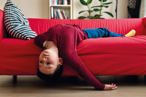 Bored child on living room. stock photo