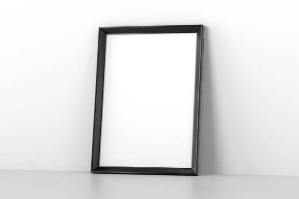 Blank wooden picture frame leaning on white wall