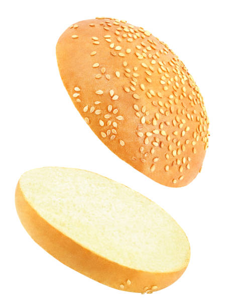 istock Burger bun cut in two part soaring, flying, falling isolated on white background with clipping path. Full depth of field. 1220177797