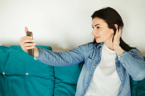 istock Woman taking a selfie with a smart phone indoors 1220178558