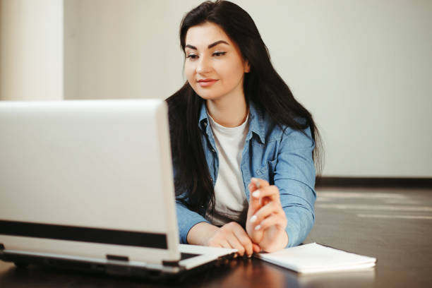 istock woman looking on laptop screen working from home 1220178702