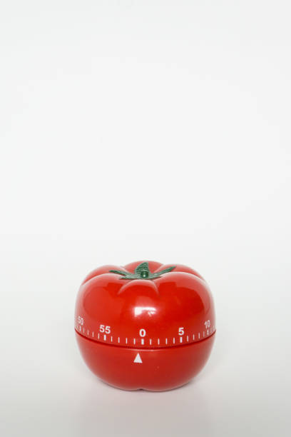istock Close up view of mechanical tomato shaped kitchen clock timer for cooking and studying. Used for pomodoro technique for time and productivity management. Isolated on white background, at 0 minutes. 1220179379