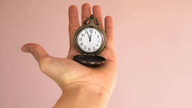 old pocket watch in young woman's hand. negative space. - clock face flash imagens e fotografias de stock