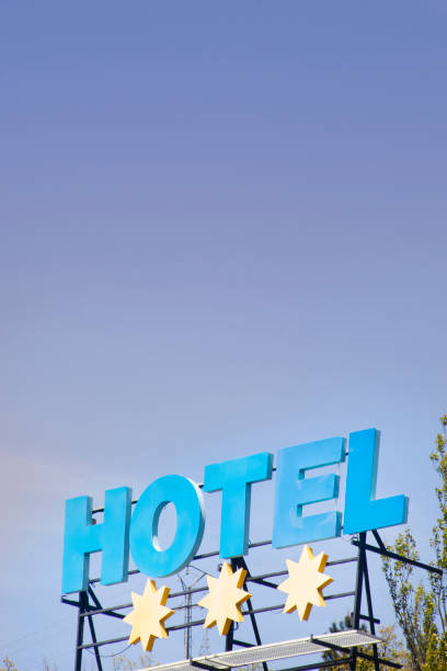 istock Hotel sign, three stars, clear blue sky background. 1220179909