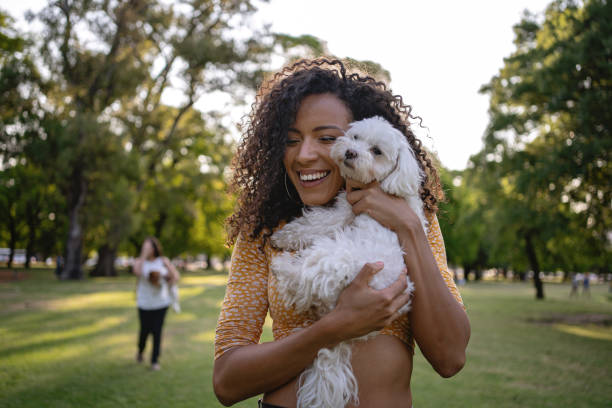 istock Joyful Latin American woman hugging her dog 1220180153
