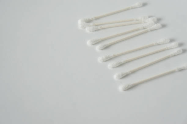 istock Q tip, or cotton bud swab top view on horizontal white background with blank empty space for copy or text; Features best health care hygiene practices to clean ear. 1220181345